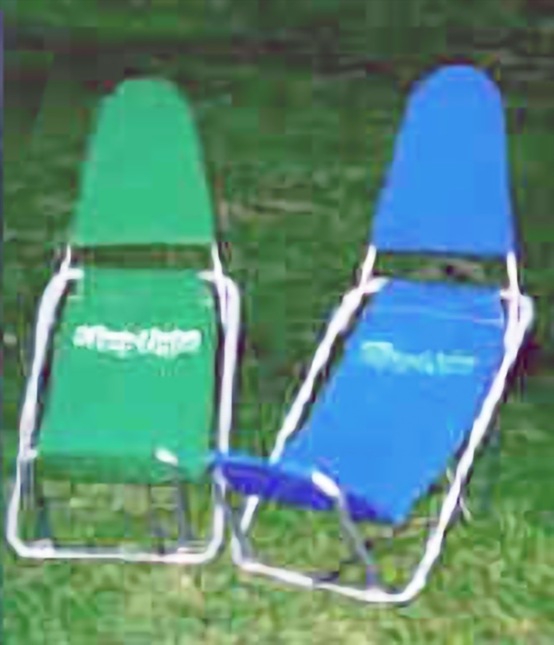 Two Sling Light chairs, royal blue and forest green, set up on grass